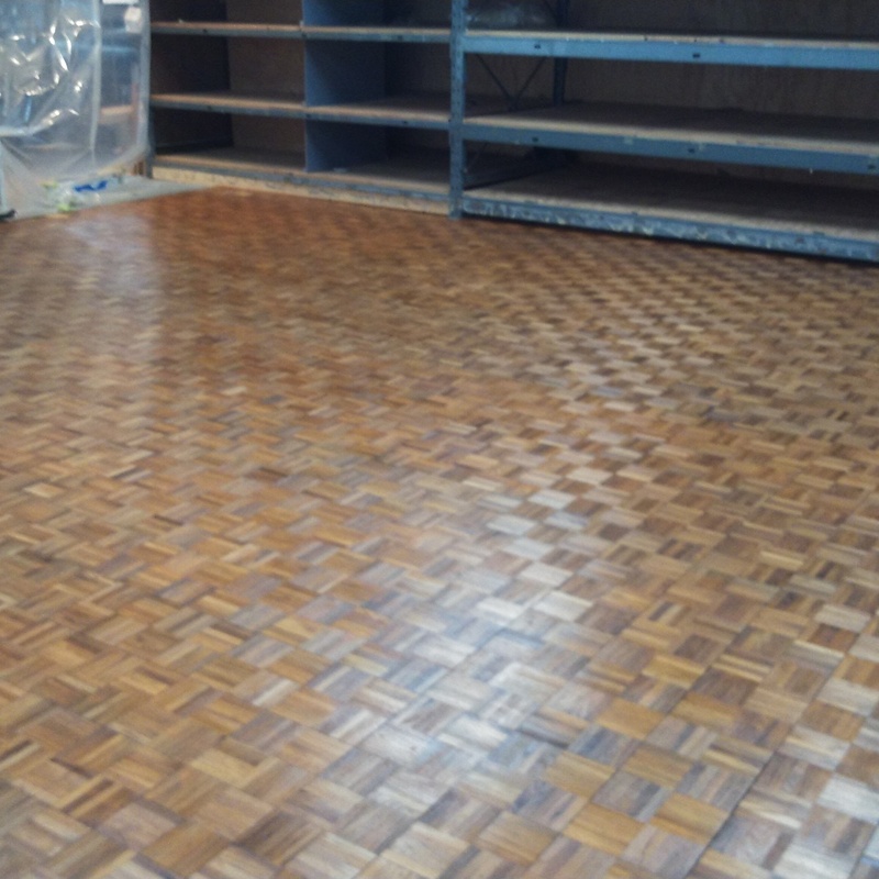 Refinishing of 50 year-old Teak finger-board parquet flooring in Hagopian's Oak Park showroom.